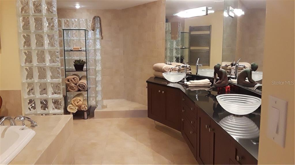 455 Longboat Club Road, Unit 401 Longboat Key, FL 34228 - Photo 14 of 28 a bathroom with a sink a toilet and mirror