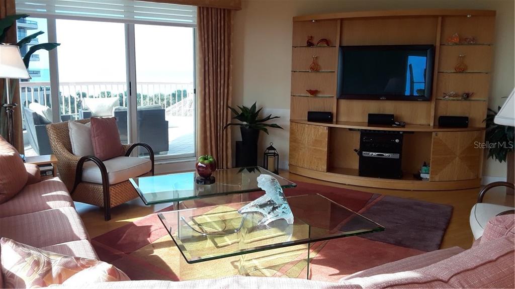 455 Longboat Club Road, Unit 401 Longboat Key, FL 34228 - Photo 2 of 28 a living room with furniture and a flat screen tv