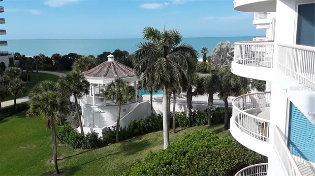 a view of a house with a yard and potted plants