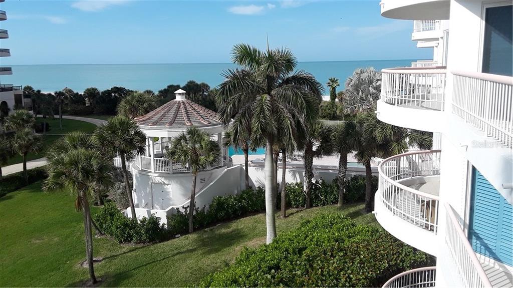 455 Longboat Club Road, Unit 401 Longboat Key, FL 34228 - Photo 24 of 28 a view of a house with a yard and potted plants