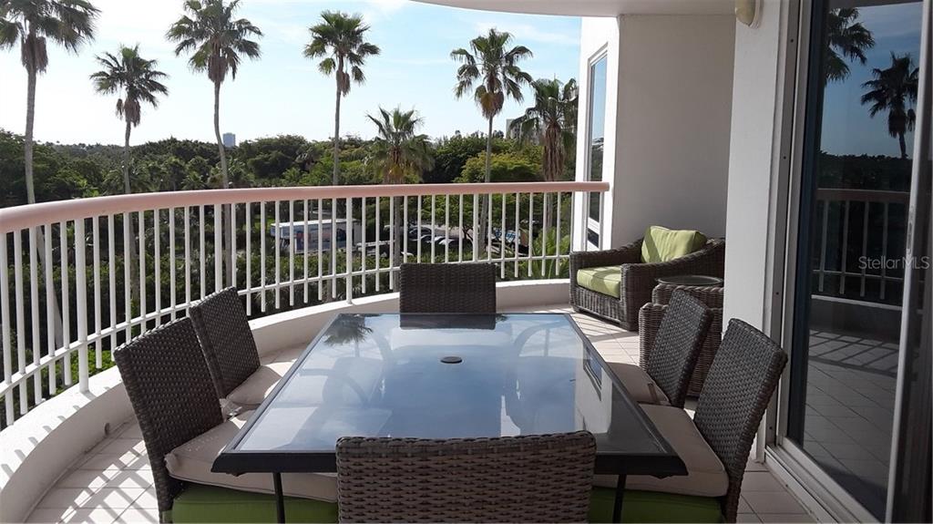 455 Longboat Club Road, Unit 401 Longboat Key, FL 34228 - Photo 26 of 28 a view of a balcony with a table and chairs