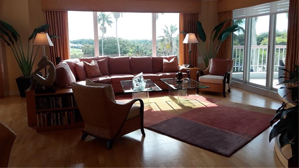455 Longboat Club Road, Unit 401 Longboat Key, FL 34228 - Photo 4 of 28 a living room with furniture rug and a large window