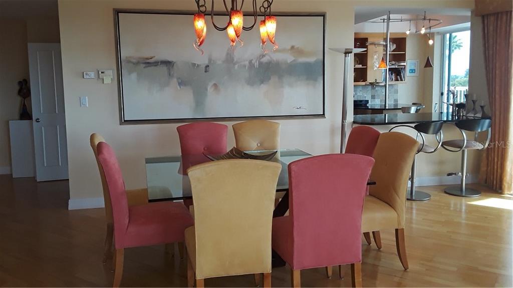 455 Longboat Club Road, Unit 401 Longboat Key, FL 34228 - Photo 6 of 28 a dining room with furniture and wooden floor
