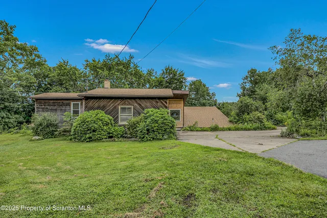 a view of an house with backyard space and garden
