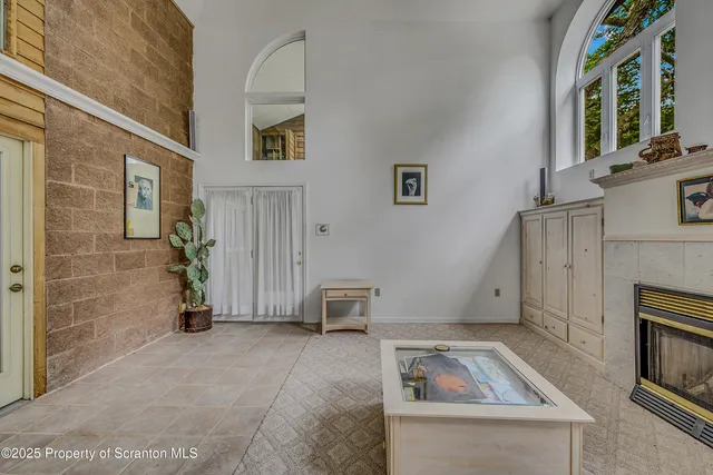a view of a tennis ground with large trees