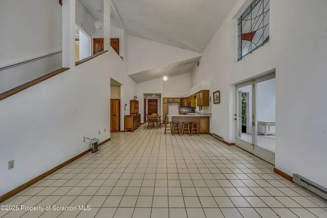 a view of a livingroom with furniture and an empty room