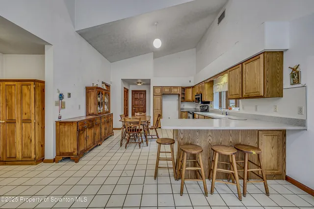 a large kitchen with stainless steel appliances lots of counter space and wooden floor