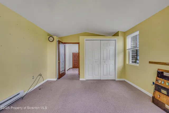 a view of a hallway with wooden floor and door