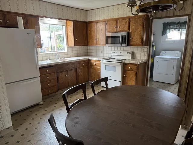 a kitchen with a sink appliances and cabinets