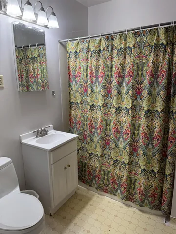 a bathroom with a sink toilet and shower