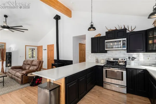 a kitchen with a sink stove and microwave