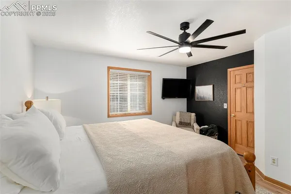 a bedroom with a bed and a tv