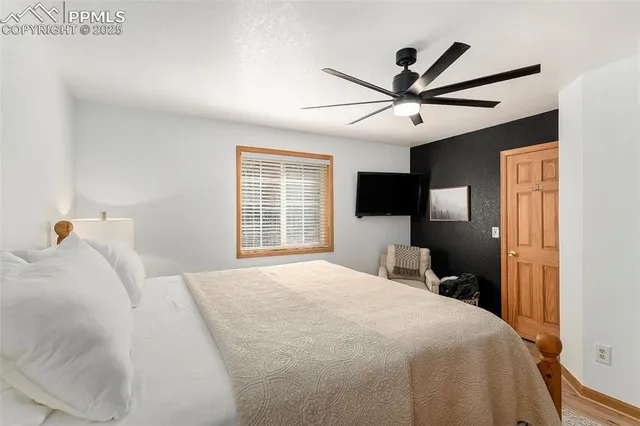 a bedroom with a bed and a tv