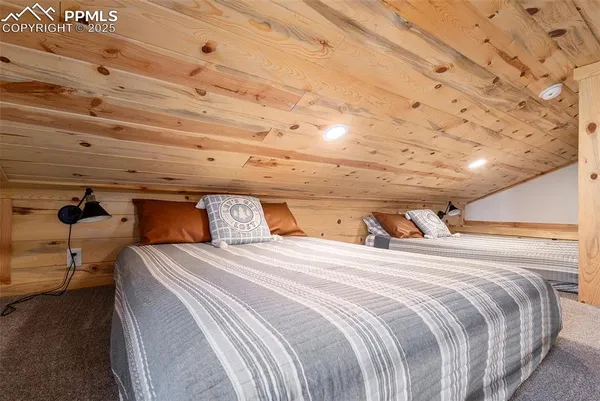 a bed sitting in a bedroom next to a window