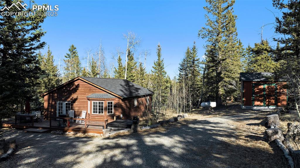 654 Piute Way Como, CO 80432 - Photo 23 of 25 a view of house with outdoor seating and trees in the background