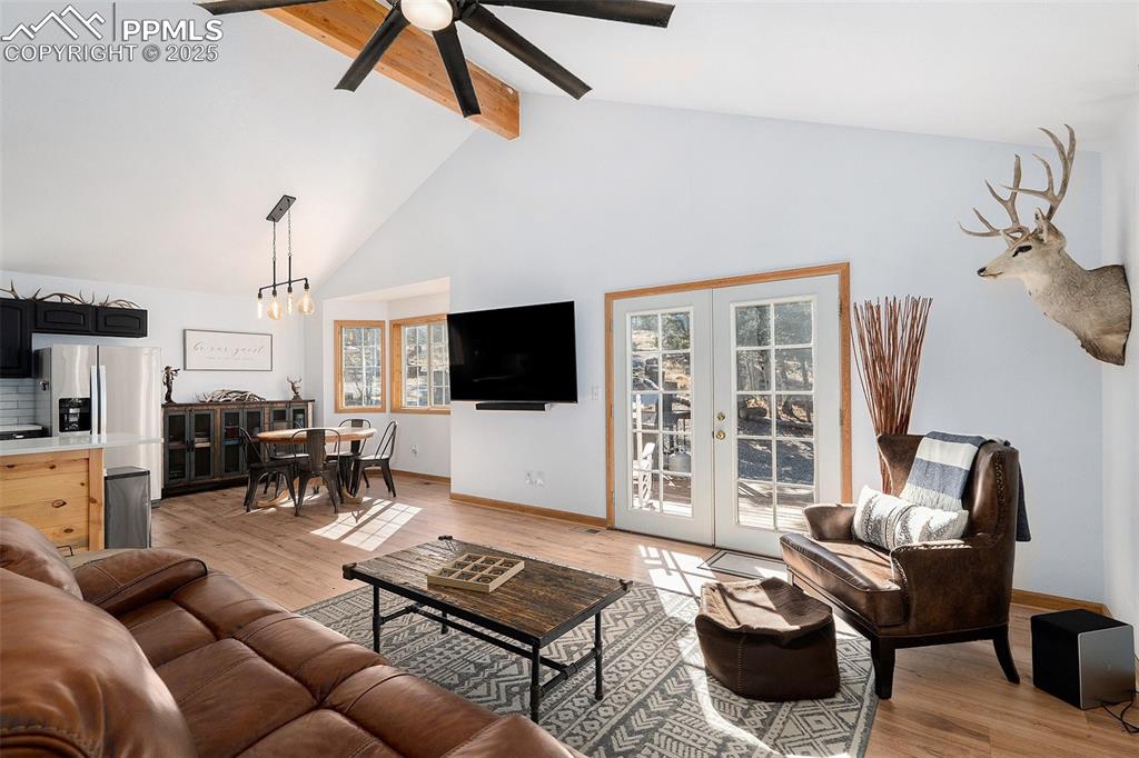 654 Piute Way Como, CO 80432 - Photo 5 of 25 a living room with furniture a flat screen tv and a floor to ceiling window