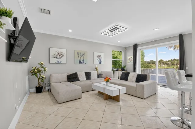 a kitchen with a dining table chairs and cabinets
