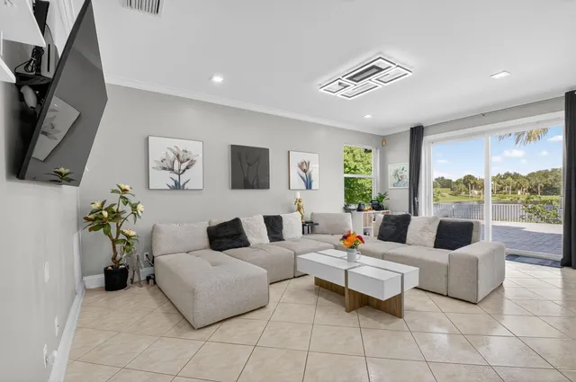 a dining room with furniture and large windows