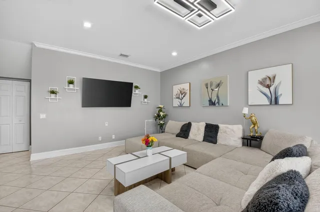 a dining room with furniture and large windows