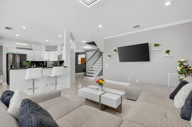 a kitchen with a refrigerator and a stove top oven