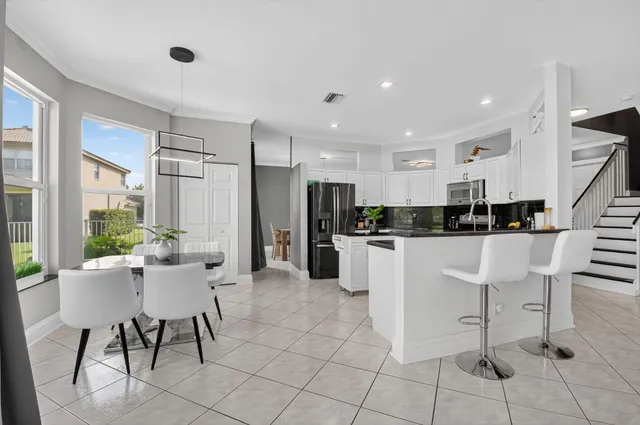 a kitchen with stainless steel appliances and white cabinets