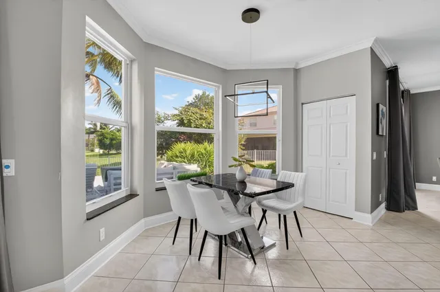 a kitchen with granite countertop a sink white cabinets and stainless steel appliances