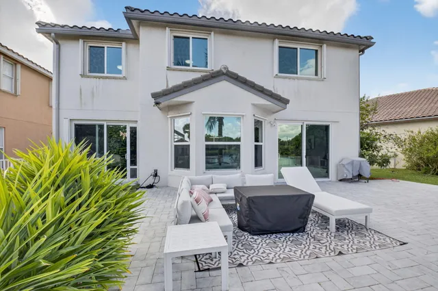 a living room with furniture and a book shelf