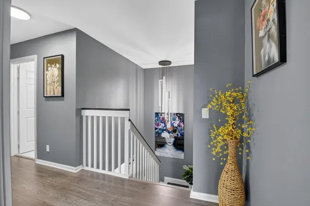 a front view of a house with a garden and palm trees