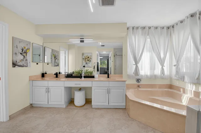 an aerial view of residential houses with outdoor space and ocean view