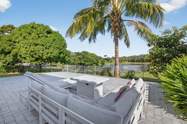 a view of swimming pool with a patio and a garden