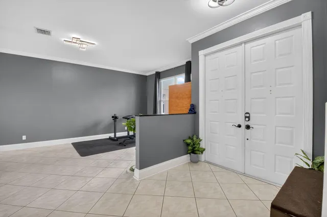 a view of a room with gym equipment and a window