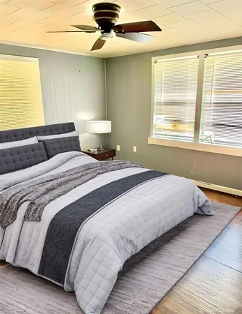 a bedroom with a bed and a window