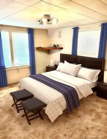 a bedroom with a bed and window