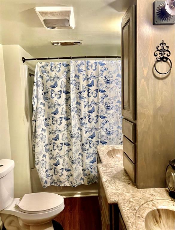 6861 Highway 4 Ringgold, LA 71068 - Photo 8 of 10 a bathroom with a granite countertop sink and a toilet