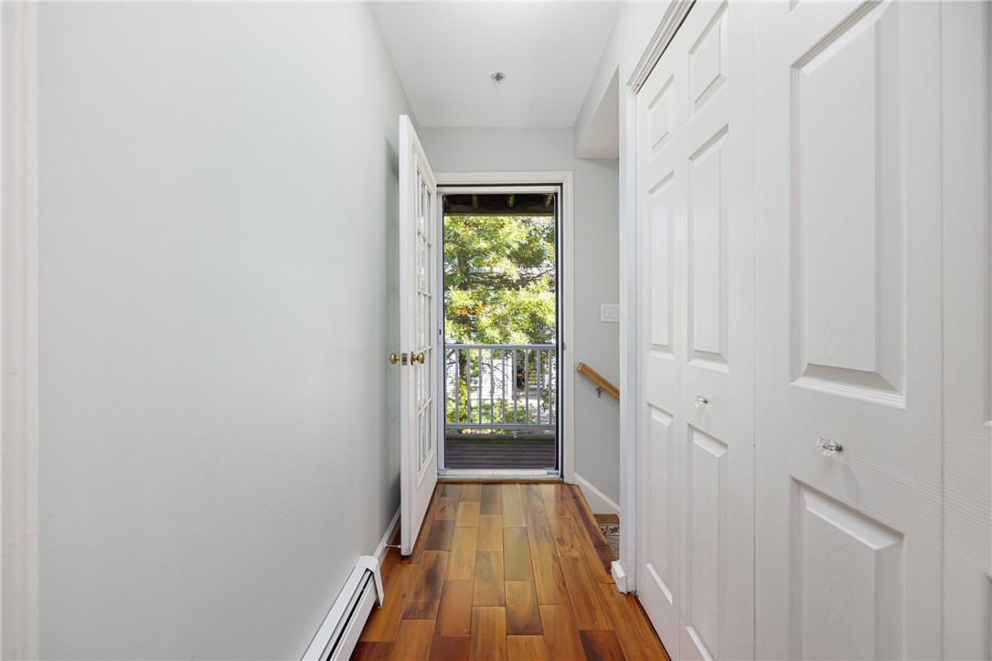 231 Maple Avenue, Unit 204 Newport, RI 02840 - Photo 15 of 40 Second floor hallway with laundry closet to the right and deck straight ahead.