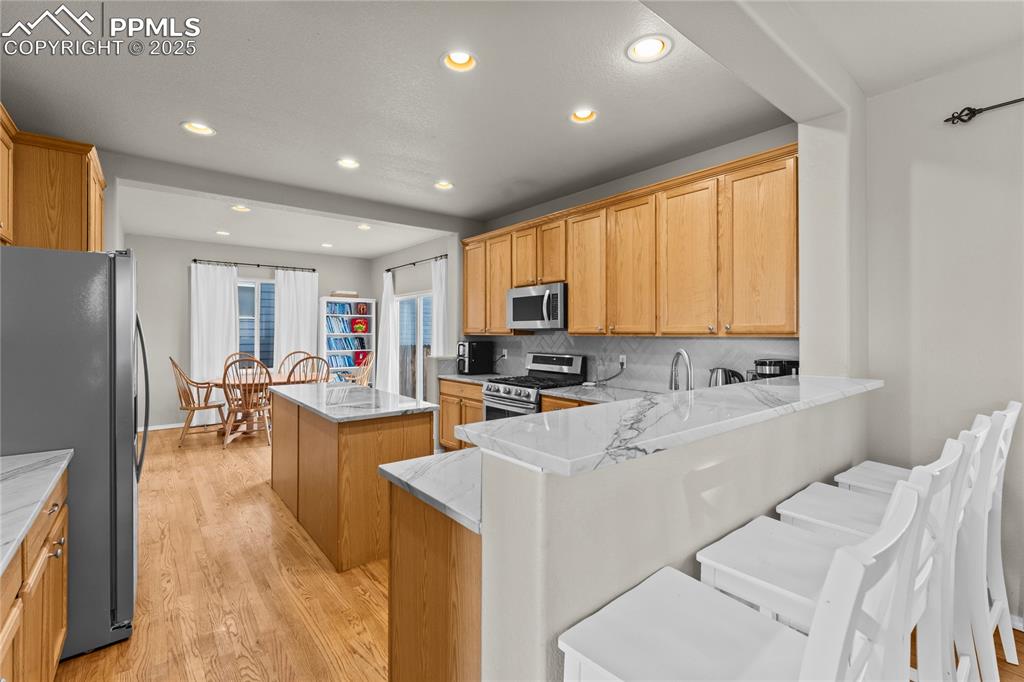 10173 Angeles Road Peyton, CO 80831 - Photo 13 of 50 a large white kitchen with lots of counter top space a sink appliances and cabinets