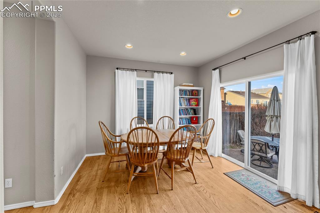10173 Angeles Road Peyton, CO 80831 - Photo 16 of 50 a view of a dining room with furniture window and wooden floor