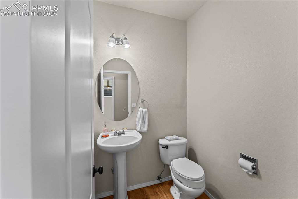 10173 Angeles Road Peyton, CO 80831 - Photo 18 of 50 a bathroom with a toilet sink and mirror