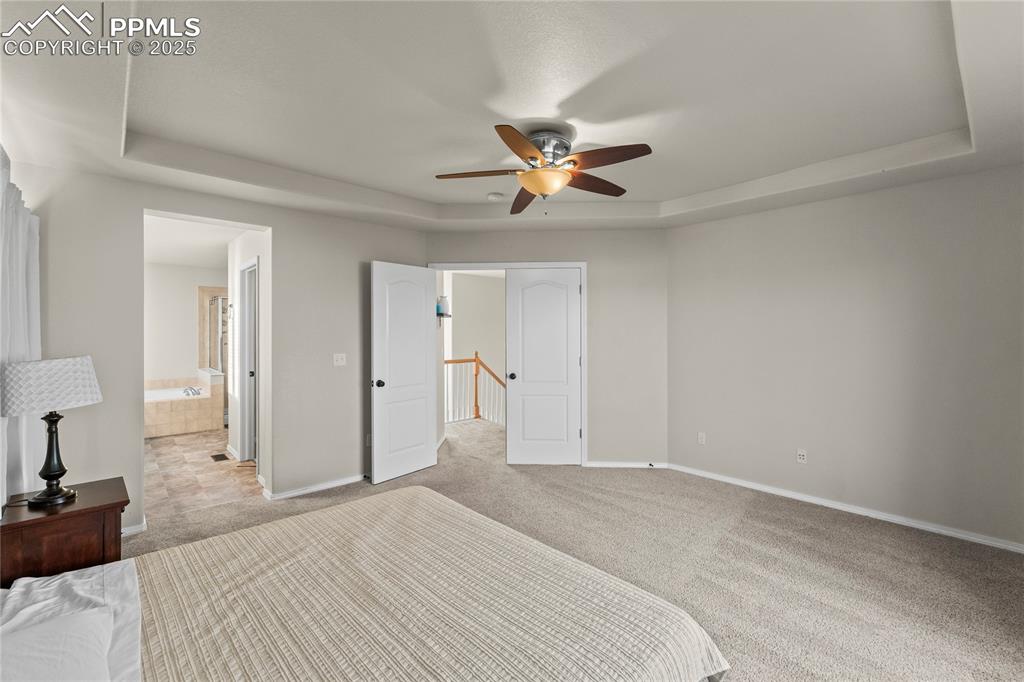 10173 Angeles Road Peyton, CO 80831 - Photo 24 of 50 a bedroom with a bed and a chandelier