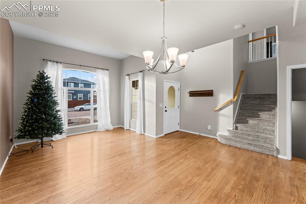 10173 Angeles Road Peyton, CO 80831 - Photo 7 of 50 a view of an empty room with a window and wooden floor