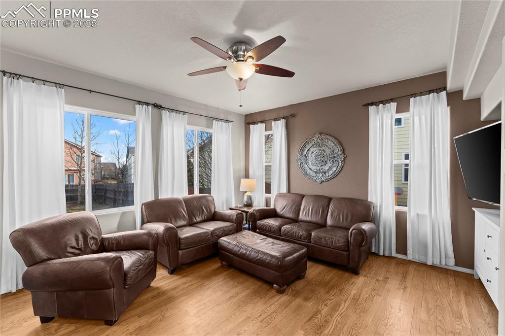 10173 Angeles Road Peyton, CO 80831 - Photo 10 of 50 a living room with furniture a large window and a flat screen tv