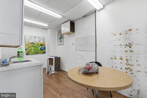 a view of a room with furniture and wooden floor