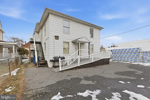 a view of a white house with a street