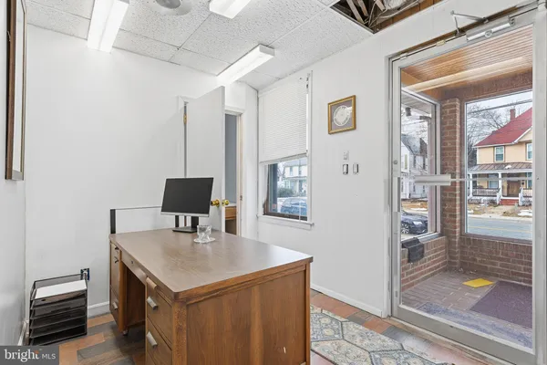 a view of a kitchen with cabinets and wooden floor