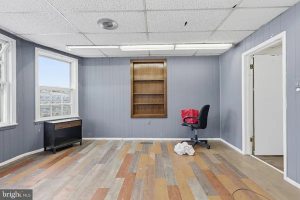 a view of a room with wooden floor and windows