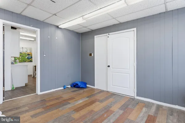 a view of a room with wooden floor and bench