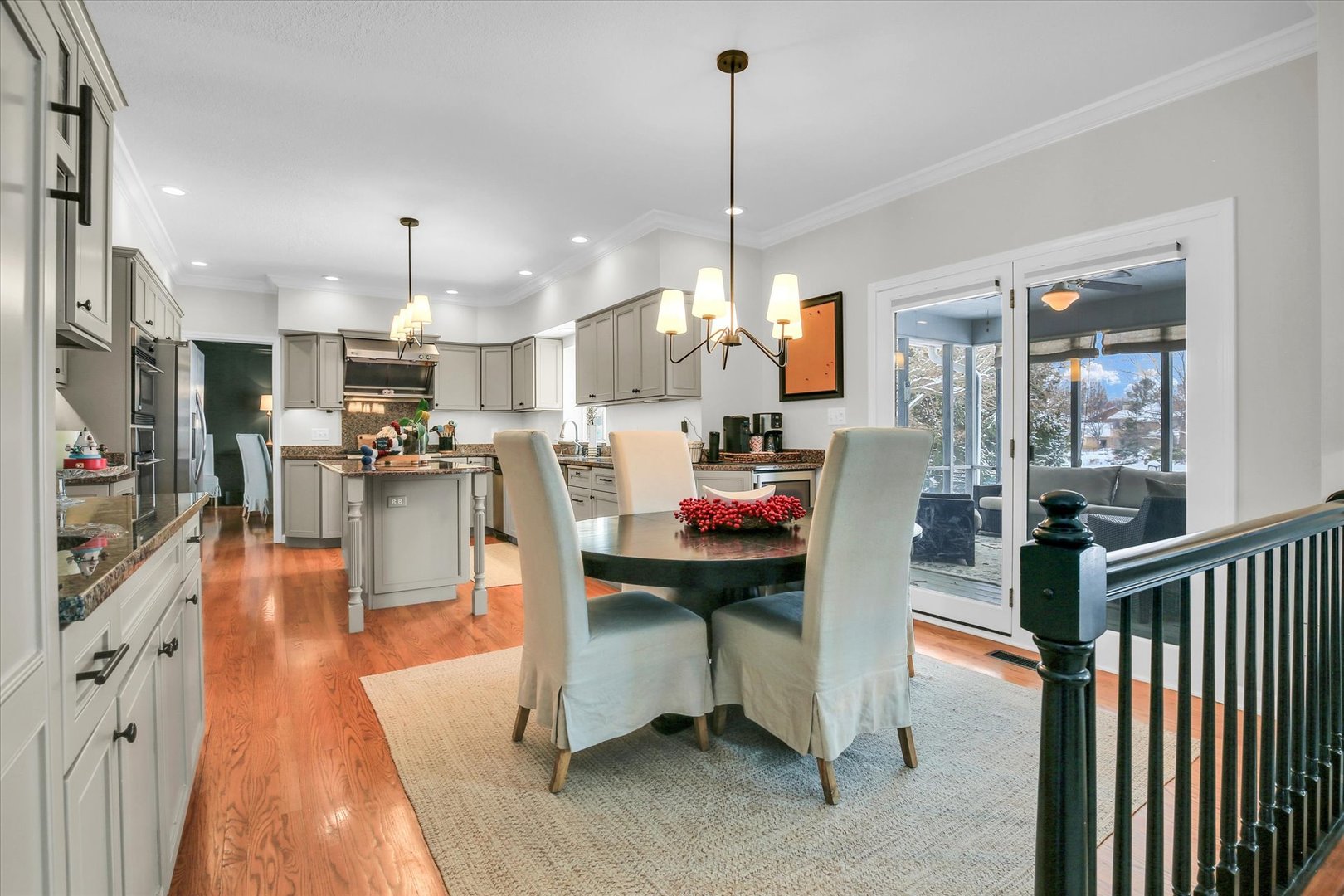 2205 Edgewater Place Champaign, IL 61822 - Photo 24 of 71 a kitchen with stainless steel appliances kitchen island granite countertop dining table chairs and a view of living room