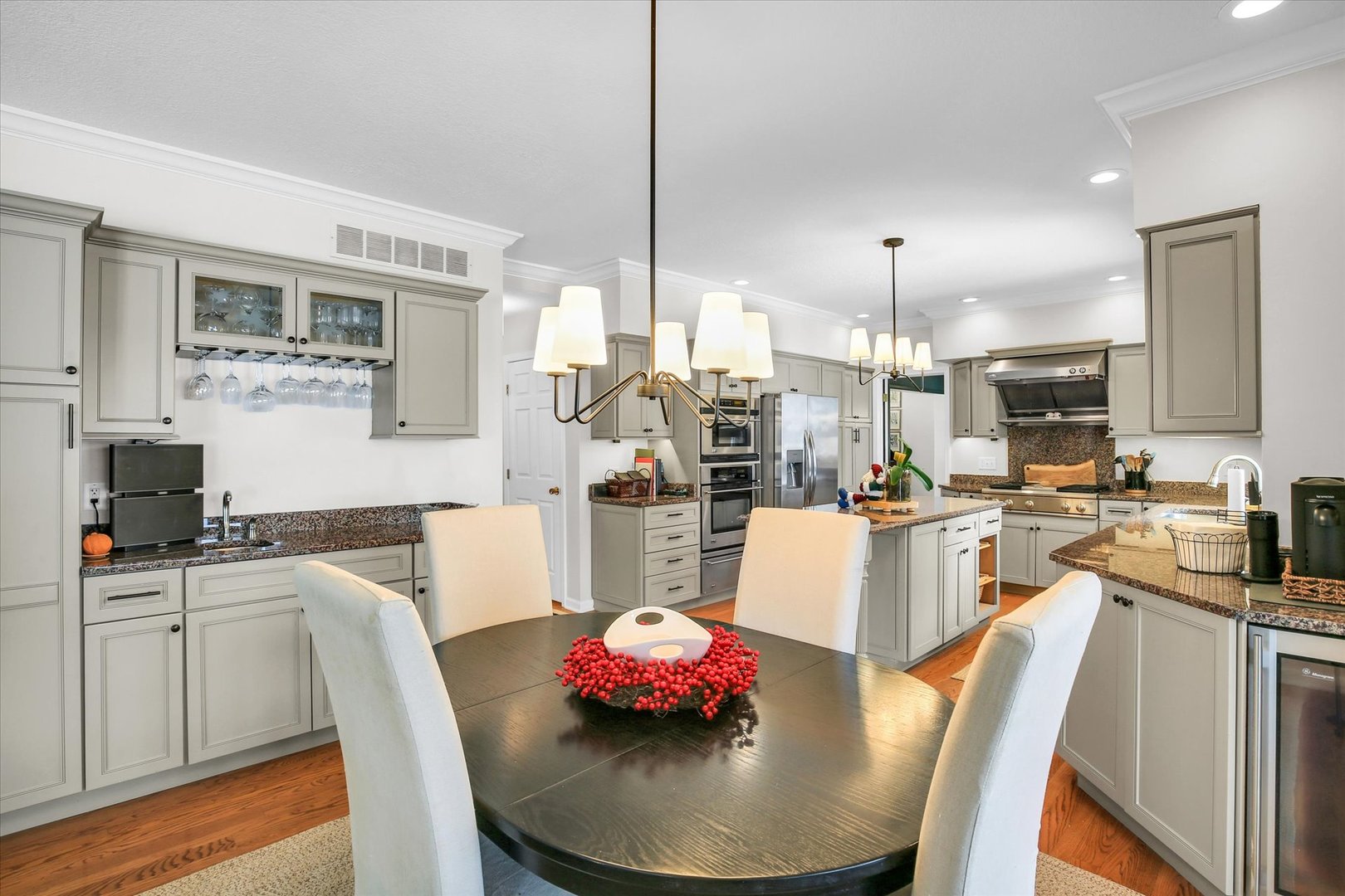 2205 Edgewater Place Champaign, IL 61822 - Photo 25 of 71 a kitchen with stainless steel appliances kitchen island granite countertop a stove a kitchen island a dining table and chairs