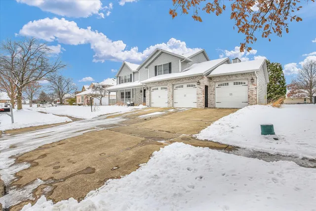 a view of a house with snow on the road