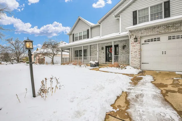 a view of a white building with swimming pool in front of house